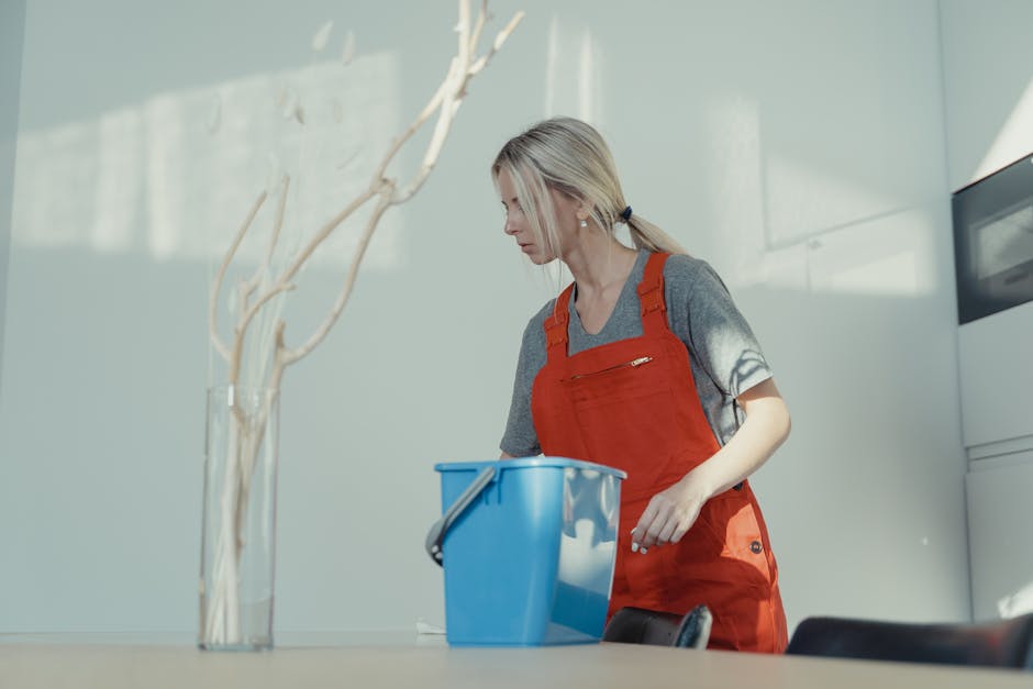 Friendly professional cleaner preparing equipment